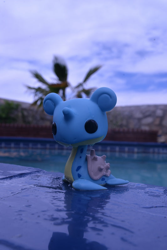 a blue bear figurine sitting on top of a pool