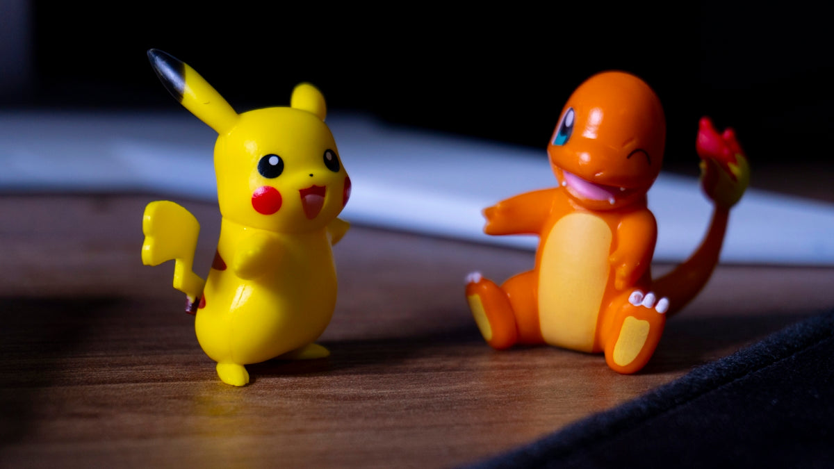 A couple of toy figurines sitting on top of a wooden table